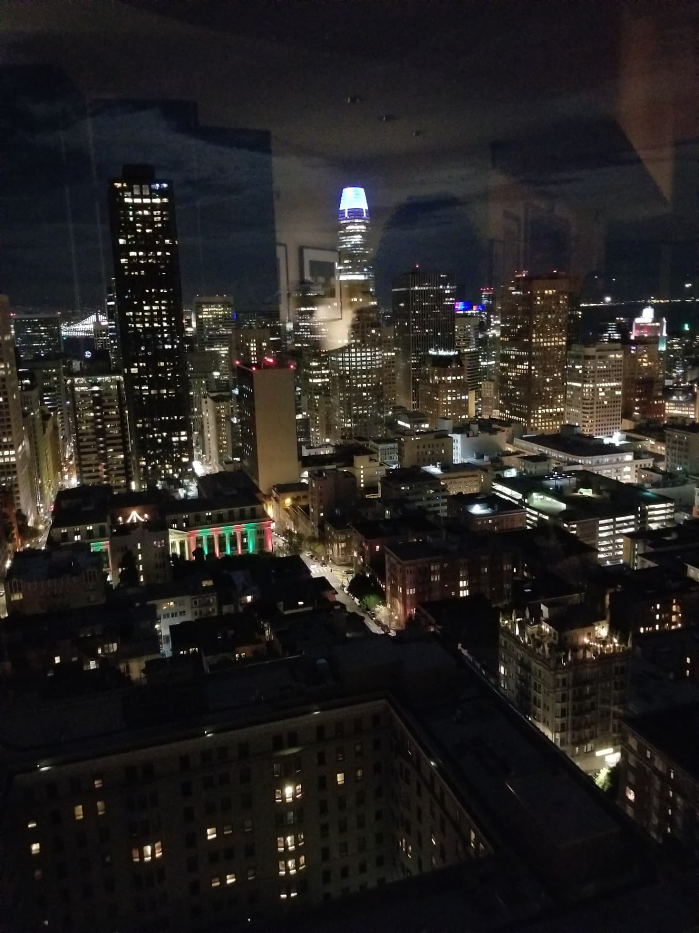 San Francisco skyline at night seen from a high club window