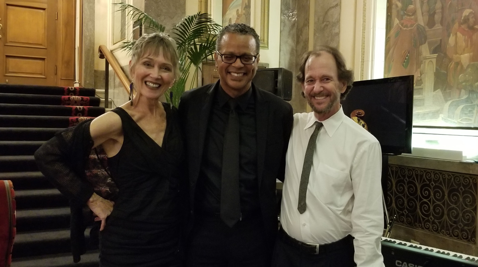 Audrey with her bassist and pianist in a marble lobby before a set