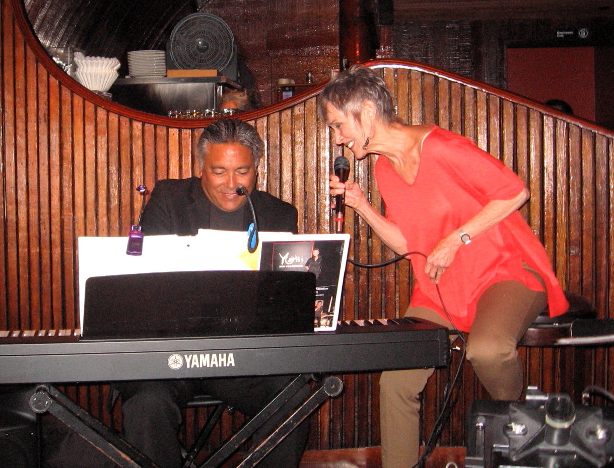 Audrey leaning in with the pianist during a club set