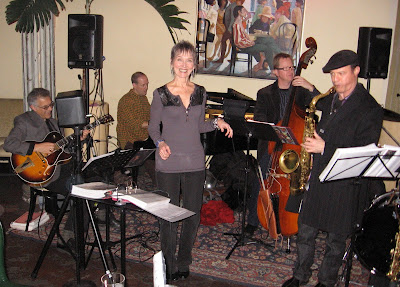 Audrey with guitar, bass and saxophone at Enrico's