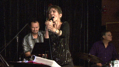 Audrey singing into a handheld microphone at Sonoma Valley Jazz
