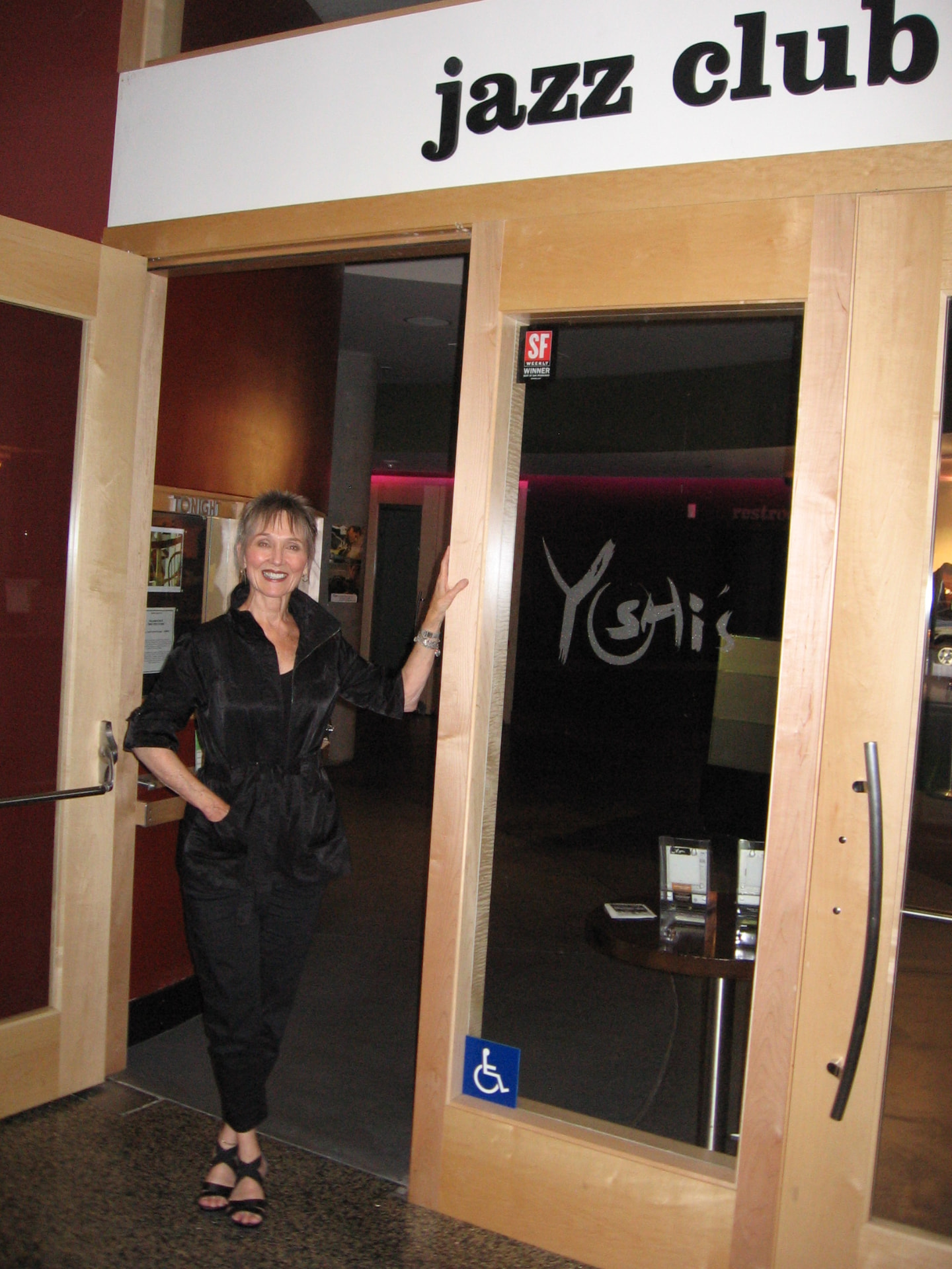 Audrey standing in the doorway of the Yoshi's jazz club entrance