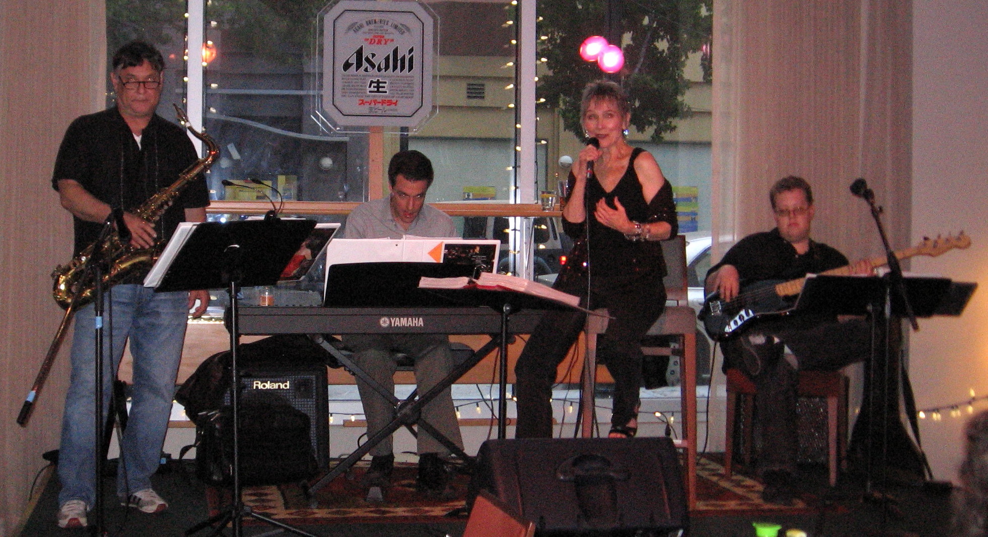 Audrey singing with her quartet — saxophone, keyboard and bass — at a club