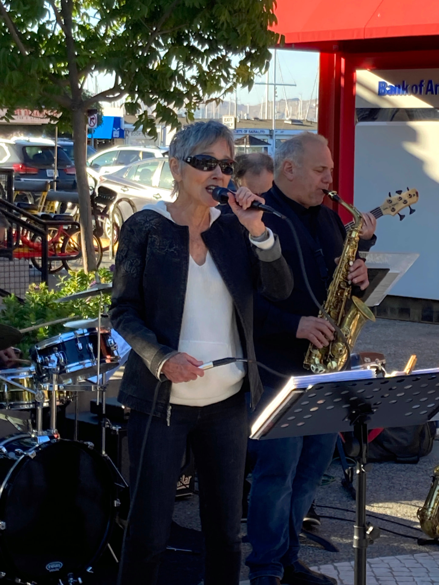 Audrey singing outdoors in Sausalito with saxophonist and bassist