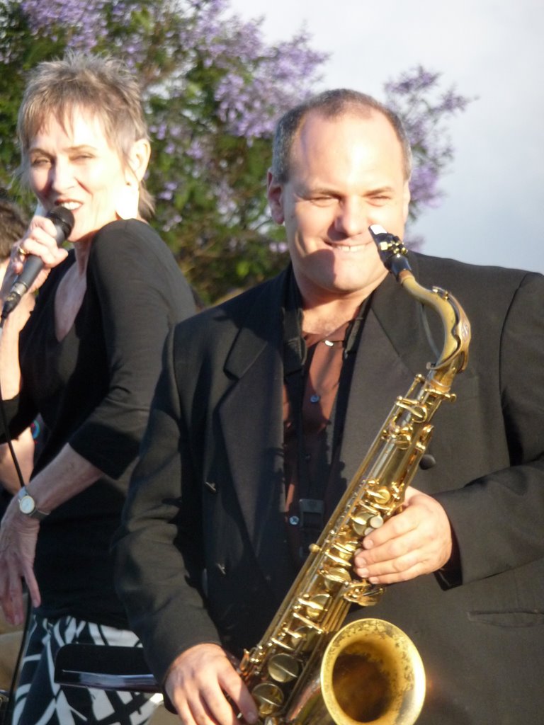 Audrey singing alongside the saxophonist outdoors